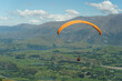 paraglider in the sky over the mountains in a sunny day in new zealand 