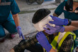 © ME Image - Paramedic first aid bandaging head to a man builder accident fall scaffolding to the floor at construction site. Worker accident at work.