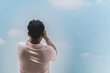 © JinnaritT - Back view of man using cell phone to take photo with cloud and sky in background. Asian male rests their eyes while looking up at beautiful sky. Man use mobile phone to take selfie. Outdoor happiness.
