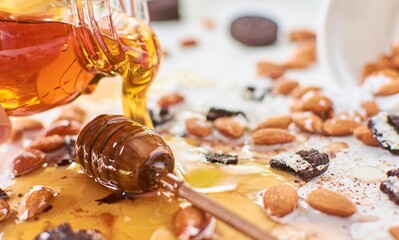 Wall Mural - Closeup of cookies with almonds and wooden honey spoon