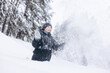 © Lyubov - Happy teenager boy sitting on snow in winter forest. Child having fun outdoors. Joyful adolescent playing in snow at snowfall. Laughing smiling kid walking in winter park in cold weather