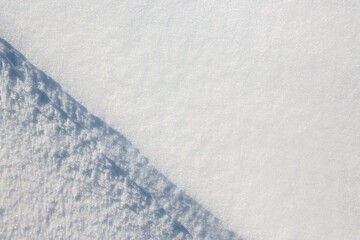Wall Mural - beautiful winter background with snowy ground. natural snow texture. wind sculpted patterns on snow 
