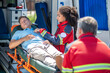 © zinkevych - Paramedic examining an unconscious man lying down on the stretcher