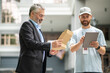 © zinkevych - Bearded elegant businessman taking the box from a courrier