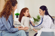 © Studio Romantic - Happy Caucasian woman with daughter are at reception of family doctor or pediatrician conducting examination with stethoscope, female clinic employee smiling sits in front of small patient