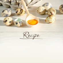 Form For Recording Recipe, Ingredients. Quail Eggs And Wooden Spoon With Yolk On Kitchen Table