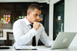 © NINENII - Businessman looking for laptop and thinking businessman reading emails on laptop in office.
