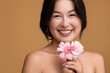 © kegfire - Happy Asian woman with gerbera