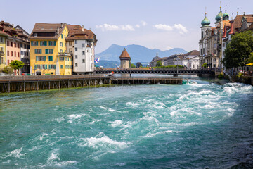 Wall Mural - LUCERNE, SWITZERLAND, JUNE 21, 2022 - The rushing waters of the Reuss River in the center of Lucerne, Switzerland