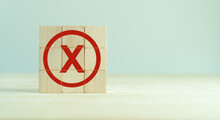 Red Cross Mark, X, Wrong Mark Sign, Rejection Sign In Wooden Cube Stack. Concept Of Negative Decision Making Or Choice Of Vote, Againt, Resist, Contravene The Law, Regulatory, Non-compliance Concept.