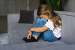 © F8  \ Suport Ukraine - No one wants to play. Depressed young girl hugging her knees and feeling like crying alone at home. Little kid lonely at home