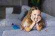 © F8  \ Suport Ukraine - Portrait of smile little girl laying on couch