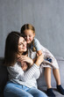 © F8  \ Suport Ukraine - People and family concept. happy smiling girl with mother hugging on sofa at home