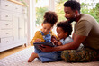 © Monkey Business - Army Father In Uniform Home On Leave With Children Using Digital Tablet