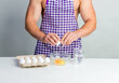 © oleg_ermak - Chef bodybuilder in protective apron and cook eggs on whie kitchen table. Muscular man cooking. Healthy food and dieting. Food additives for sportsman, daily calorie diet