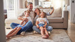 © Alexis Scholtz/peopleimages.com - Happy, relax and selfie with family in living room for love, media and support together. Smile, support and and internet with parents and children posing for phone camera at home for social media