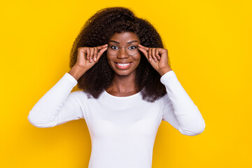 Photo of cheerful charming girl hands touch glasses toothy smile isolated on yellow color background