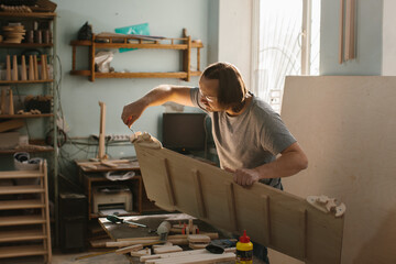 A carpenter makes a Montessori climbing set for children in his workshop.