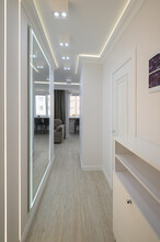 White Long Narrow Hallway With A Mirror