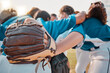 © L Ismail/peopleimages.com - Baseball people and sport team together for huddle at match game on field for motivational support. Professional girl athlete softball group prepare to play outdoor tournament with strategy talk.