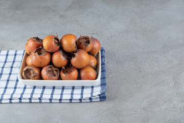 Wall Mural - A white board with ripe persimmons on a tablecloth