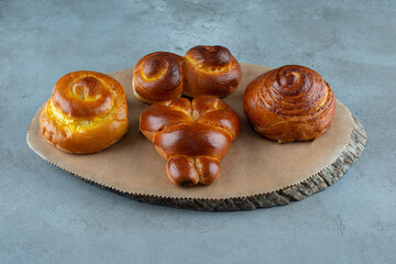 Various sweet pastries on wooden piece