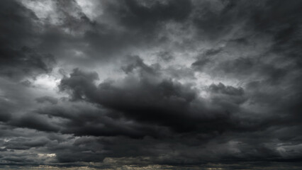 dark dramatic sky with black stormy clouds before rain or snow as abstract background, extreme weath