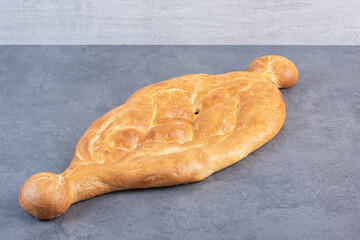 Wall Mural - Whole loaf of half-sliced tandoori bread on marble background