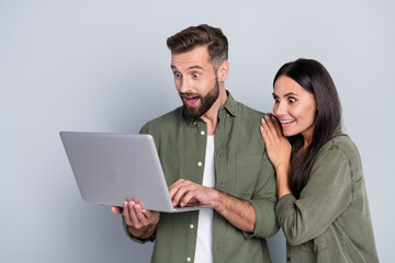 Poster - Photo of shocked guy lady spouses searching netbook incredible discounts news isolated over grey color background