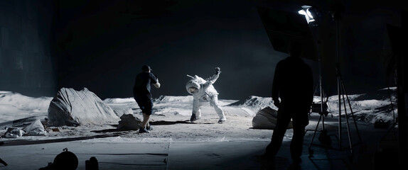 Wall Mural - wide behind the scenes, cinematographer shooting viral video for social account on a large moon land
