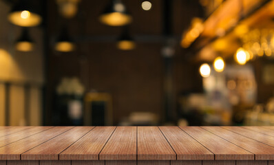 Wall Mural - Empty wooden table top with lights bokeh on blur restaurant background.