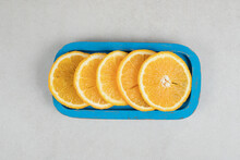 Fresh Orange Slices On Blue Plate