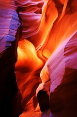 Wall Mural - Vertical shot of the Antelope Canyon X in Arizona USA with colorful lights on the sandstones