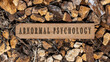 Abnormal psychology. Written on wooden surface. Wooden frame on pieces of stone. Diseases and cures.