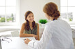 © Studio Romantic - Happy child patient having a medical consultation with a doctor in the clinic. Cheerful beautiful teenage girl sitting at a white table, talking to her physician, listening to her advice and smiling