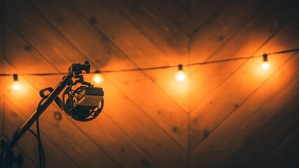 Condenser microphone hanging on a stand in a recording room