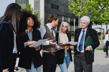 Business multiracial people meeting outdoors in the city with office building on background - Focus on senior man face