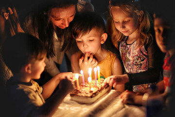 family celebrating birthday with candles