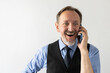 © Mangostar - Portrait of excited mature businessman talking on mobile phone. Senior Caucasian manager wearing formalwear listening to client with excited expression. Mobile technology concept
