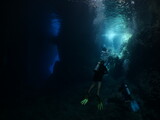 Fototapeta Do akwarium - sun beam and rays sun shine underwater in caves and caverns backgrounds scuba divers to explore