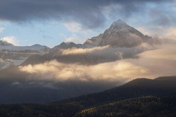 Wall Mural - USA, Colorado, Uncompahgre National Forest. Sunrise on clouds below Mount Sneffels.