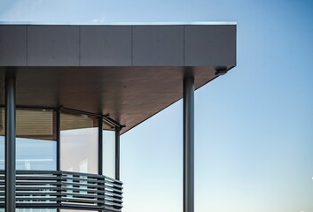 Canvas Print - Modern building with glass windows against a blue sky