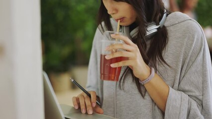 Aufkleber - Productivity woman student with laptop working on a website for graphic design project and drink tea in creative workspace or university cafe. Gen z employee at a digital marketing company in Tokyo