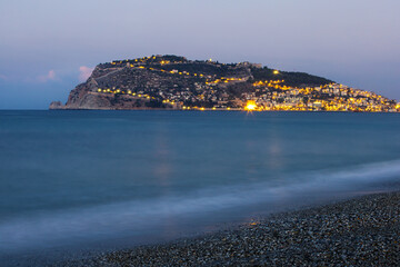 Wall Mural -  Beautiful night panoramic view of the city Alanya, the Mediterranean Sea, the Red Tower, Alanya Castle.