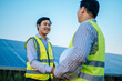 © Johnstocker - Two engineer handshake together on solar panel background