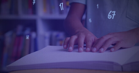 Sticker - Digital composition of numbers and symbols floating against mid section of boy reading a book in bra