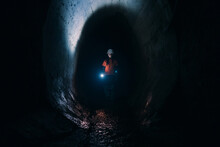 Female Digger With Flashlight Explores The Tunnel