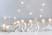 Happy New Year 2023 Background New Year Holidays Card With Bright Lights,gifts And Bottle Of Hampagne