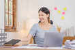 © David - Young business Asian woman working at desk with laptop computer in home office, Tax Accountant Young Asian woman Doing Sales Invoice Accounting.