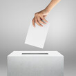 Election vote, hand holding ballot paper for election vote concept at grey background.